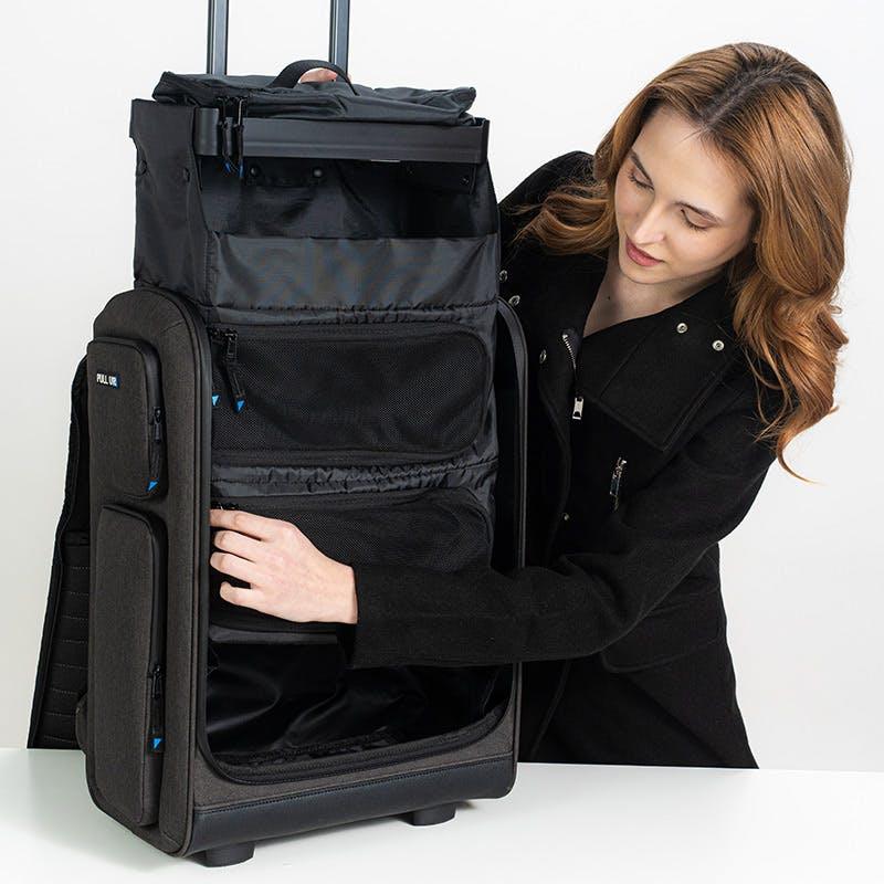 Woman organizing items in Pull Up Backpack – perfect travel companion with instant access